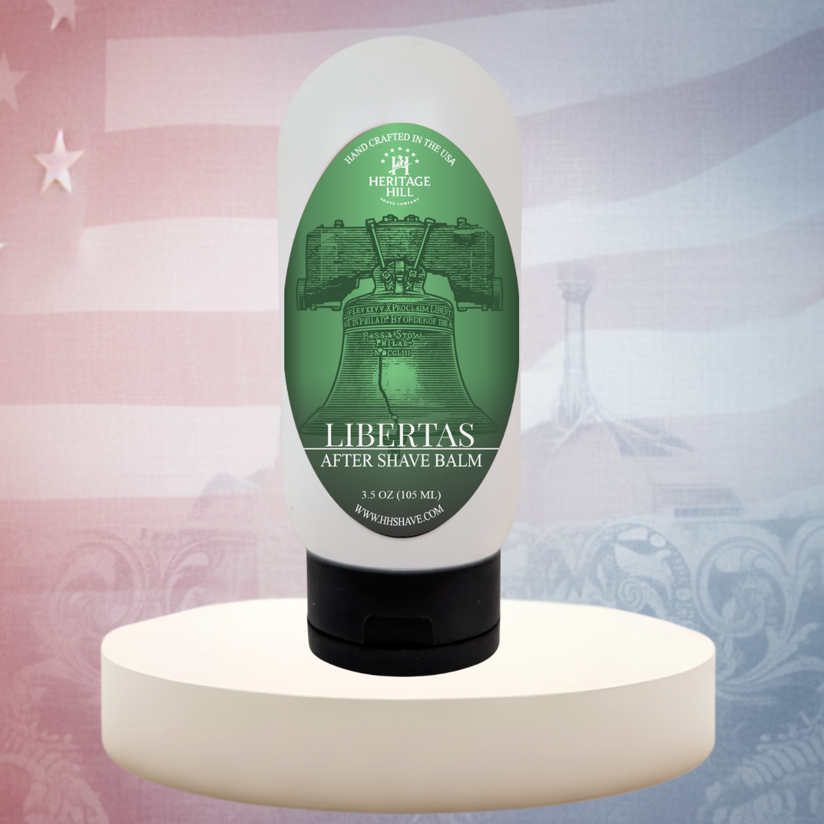 Bottle of Libertas After Shave Balm on a white pedestal with a decorative background