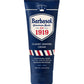 A hand holding a tube of Barbasol Classic Shaving Cream with the label '1919' prominently displayed, indicating the brand's year of invention.