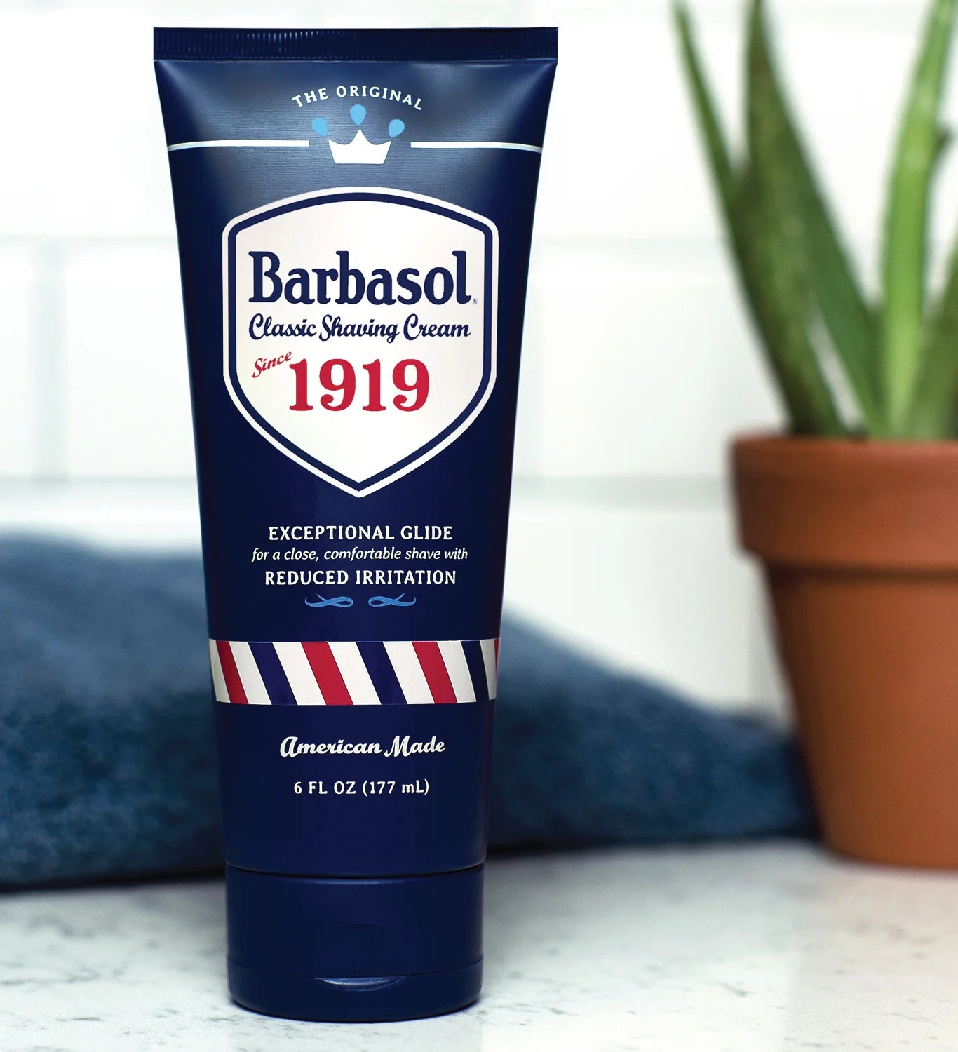 A tube of Barbasol Classic Shaving Cream with a blue and white color scheme, featuring the year 1919 and branding details.