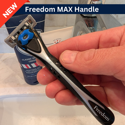 Hand holding a Freedom MAX Handle razor with shaving cream and razor in the background.