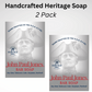 Two bars of soap with packaging that features patriotic themes. One is labeled 'Patriot Bar Soap' with a illustration of a man's profile in a hat, and the other is labeled 'John Paul Jones Bar Soap' with a similar illustration in a grey scale.