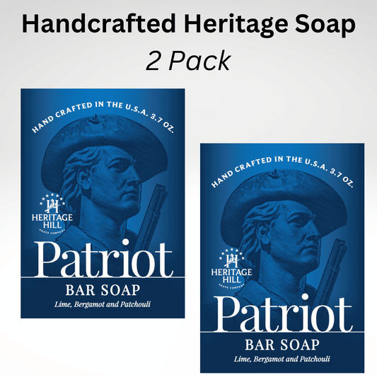 Two bars of soap with packaging that features patriotic themes. One is labeled 'Patriot Bar Soap' with a illustration of a man's profile in a hat, and the other is labeled 'John Paul Jones Bar Soap' with a similar illustration in a grey scale.