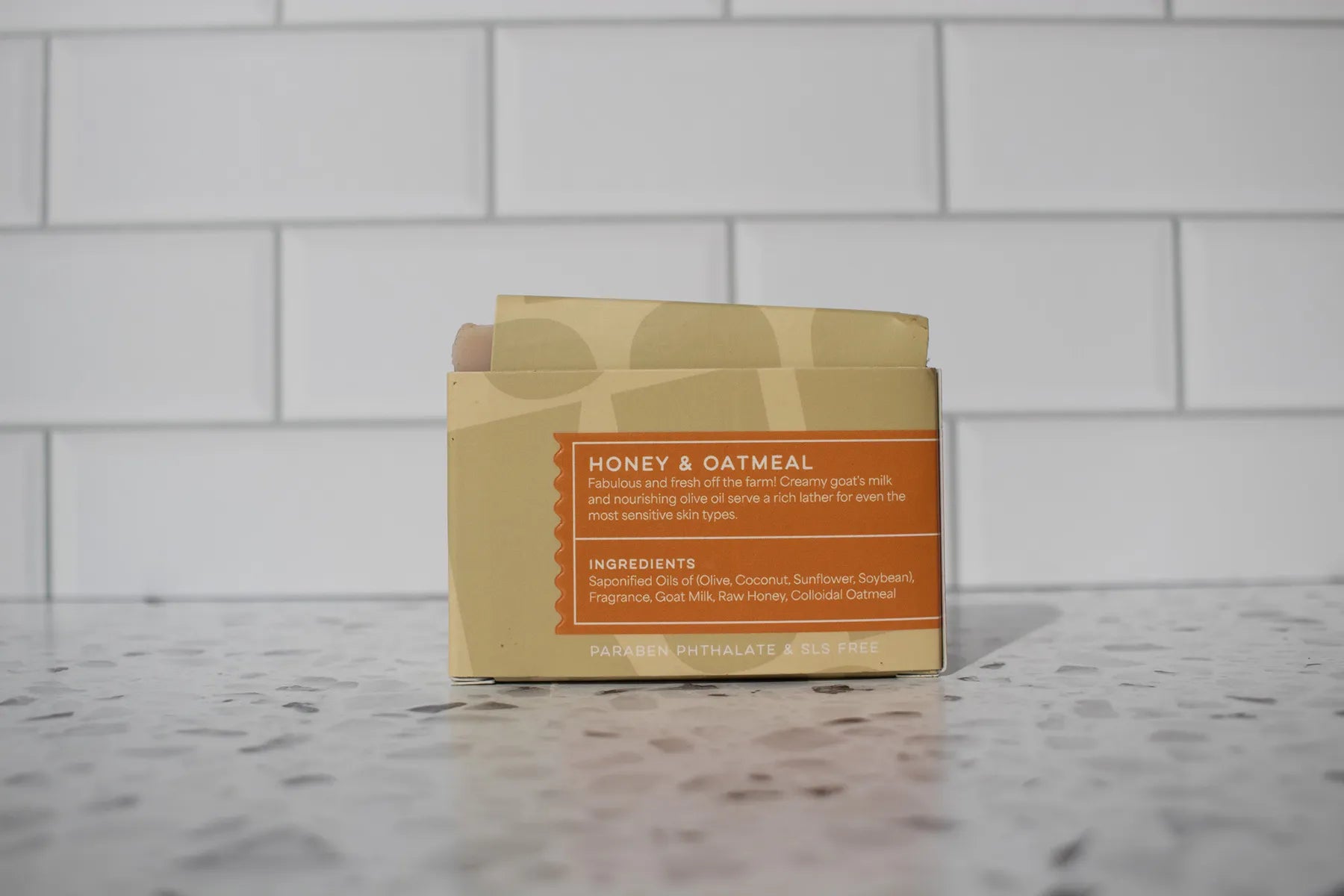 Bar of soap with 'Honey & Oatmeal' label on a tiled surface